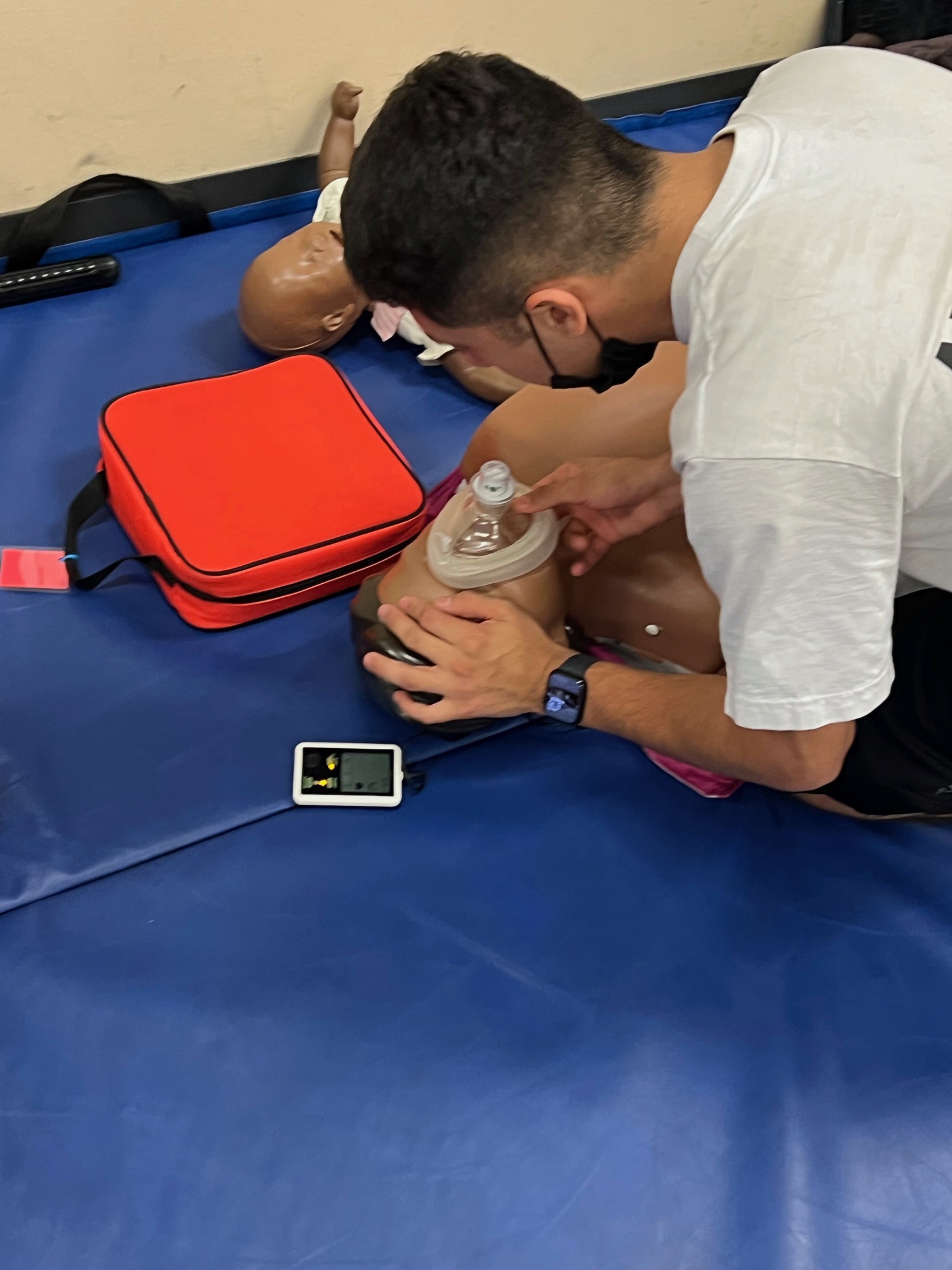 Trainee performing CPR on a manikin during certification